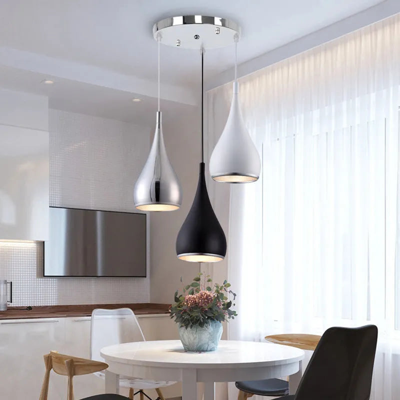 Minimalist black iron chandelier bedside lamp with three adjustable heads on a long platter.