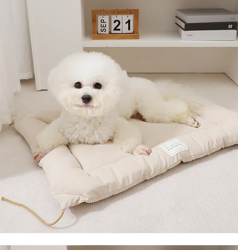 Beige tied cage cushion for small dog in crate showing secure attachment and warm bedding platform.