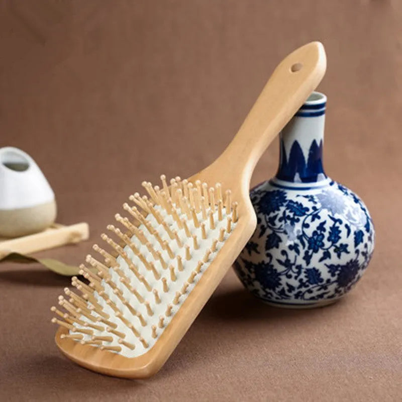 Wooden paddle cushion hairbrush with cushioned bristles, 22cm length for scalp massage and detangling