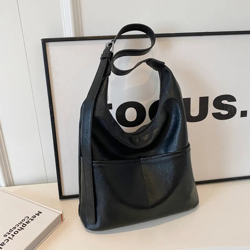Women's large-capacity shoulder bag in soft PVC with bucket shape and stitching detail, available in black, coffee, brown, mud, beige