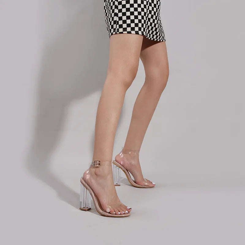 Women's Apricot high heel sandals with a transparent glass heel and a front buckle fastener.