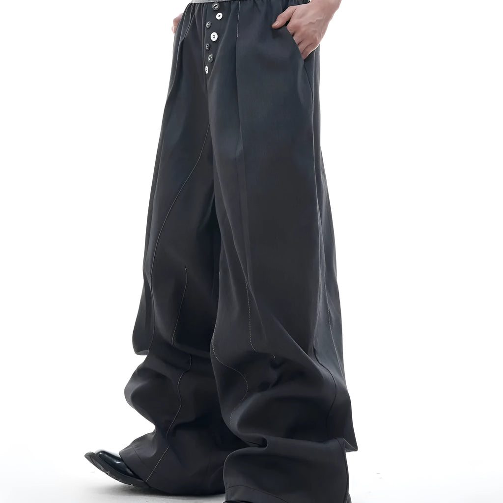 Straight-leg high-waisted trousers in grey fabric with button detail on the leg.