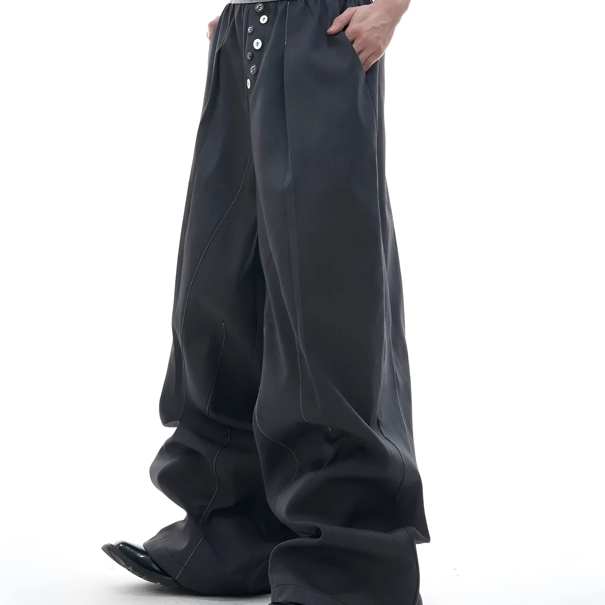 Straight-leg high-waisted trousers in grey fabric with button detail on the leg.