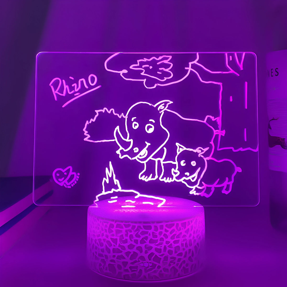 Rewritable night light with acrylic display panel, ABS base, and USB cable showing a drawn message