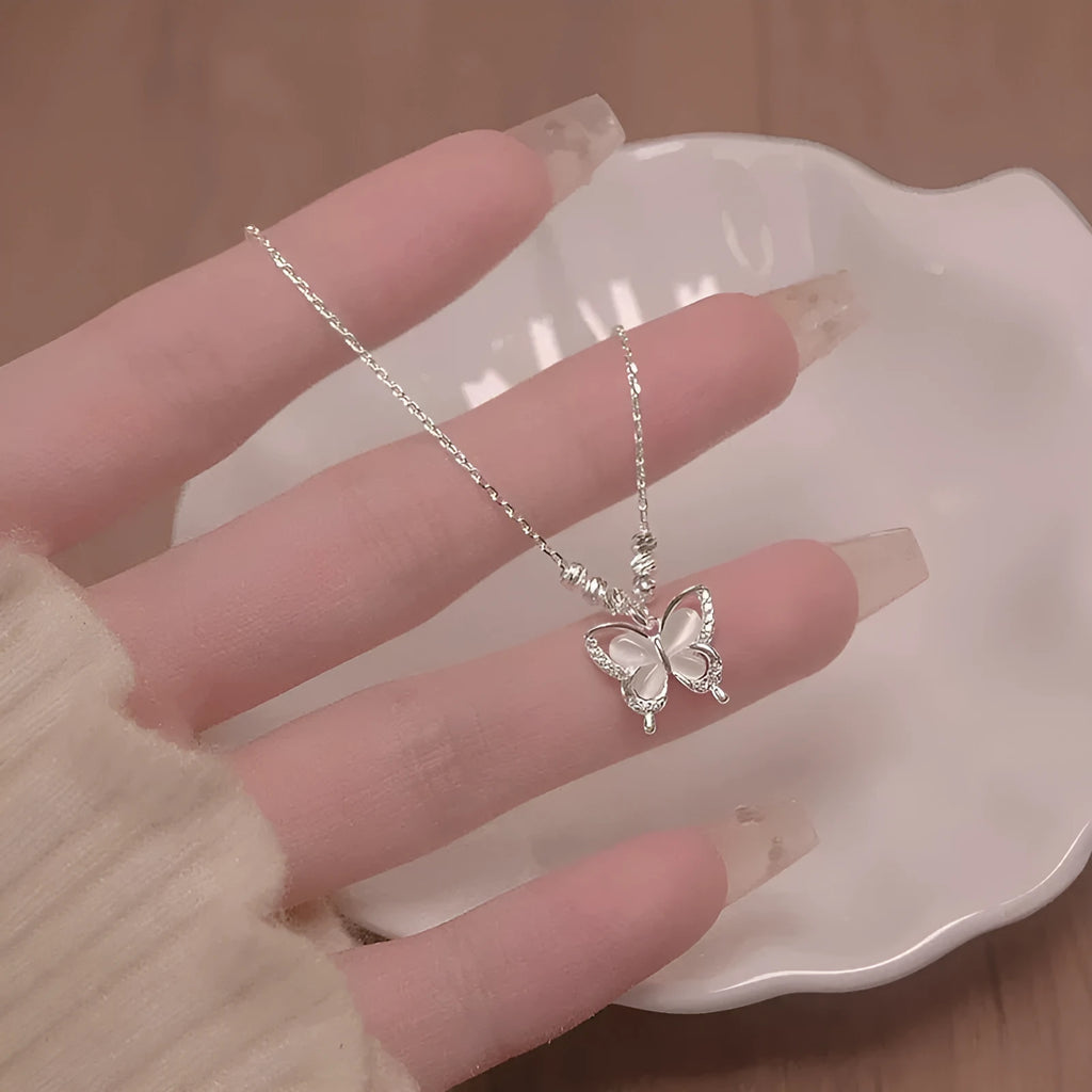 Women's square line opal butterfly pendant necklace on a silver adjustable cross chain.