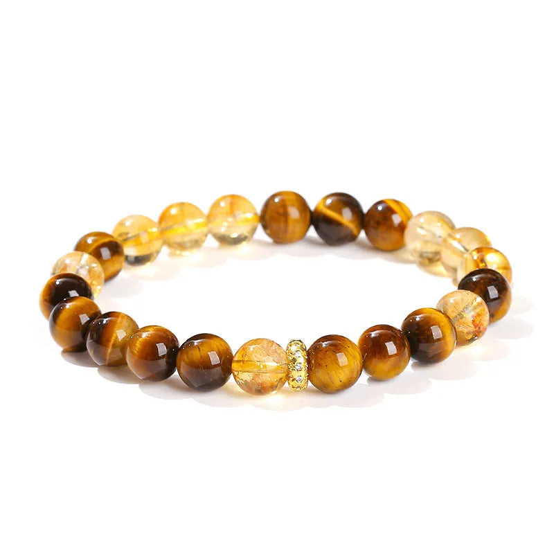 Close-up of a women's yellow tiger-eye stone and crystal bracelet with 8mm round beads.
