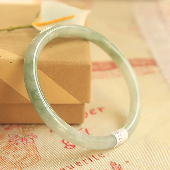 Traditional green jade waxy Chinese bracelet with geometric design showing 10mm profile