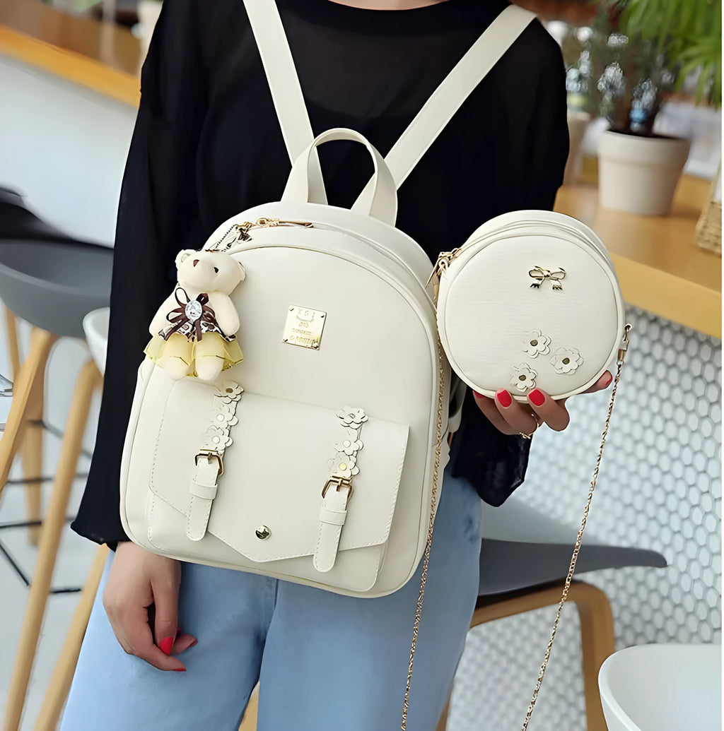 Women's black PU leather three-piece set showing backpack, shoulder bag, and card purse together.