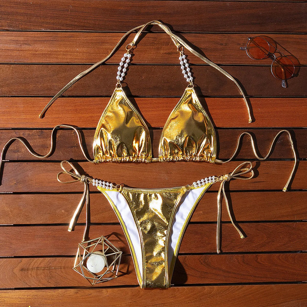 Gold women's halter bikini with front lace-up tie and decorative pearl chain detail.
