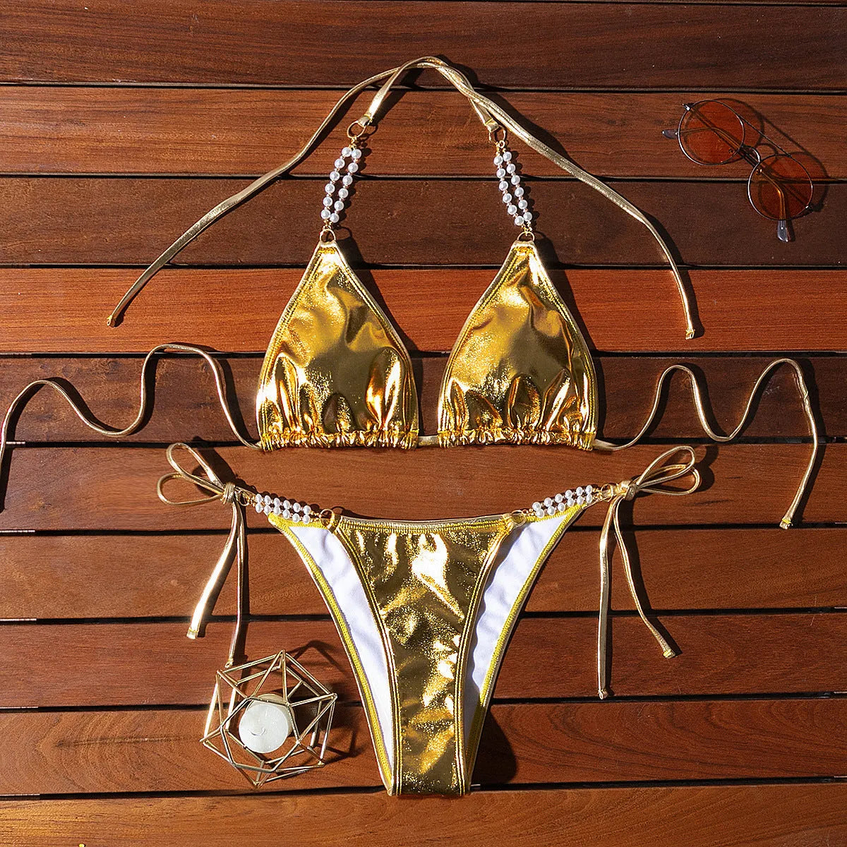 Gold women's halter bikini with front lace-up tie and decorative pearl chain detail.