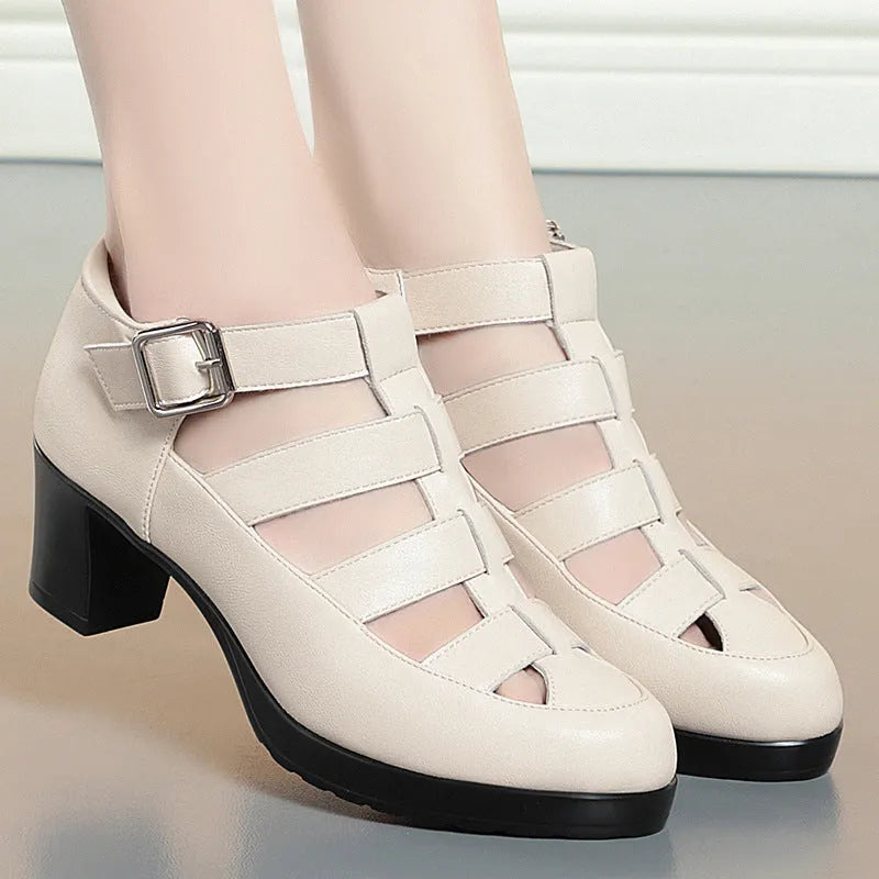 Women's beige closed toe sandals with chunky heel, woven ankle-strap buckle, and back zipper on a plain background