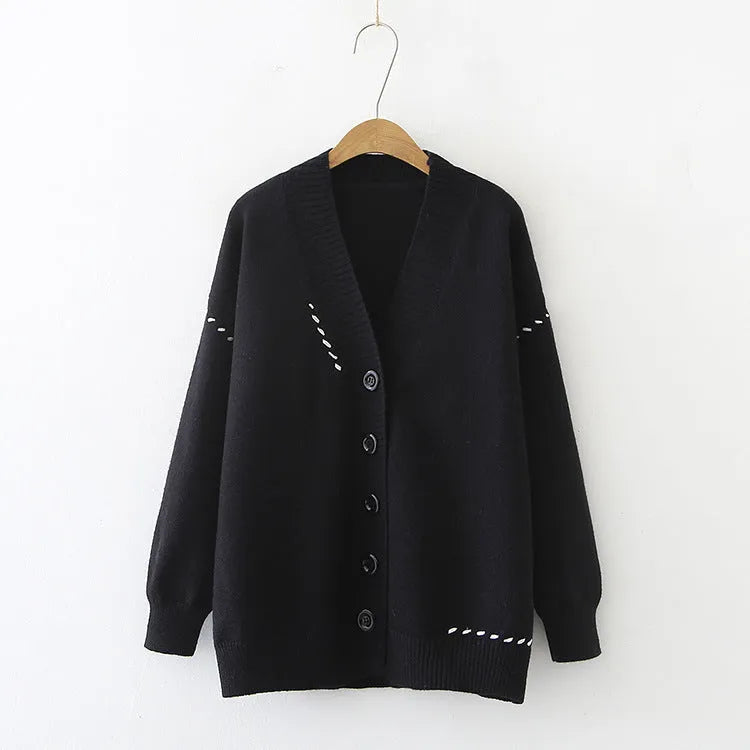 Women's loose-fitting knitted cardigan top coat in black, showing long sleeves and solid colour design.