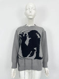 Grey loose women's alpaca wool pullover sweater with tassel detail on a hanger.