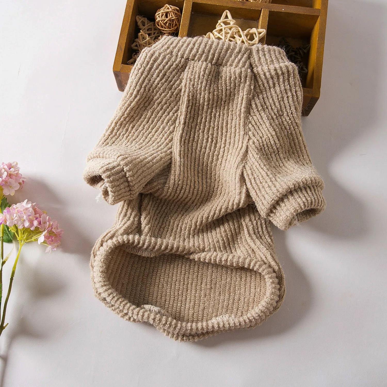 Brown cloth dog sweater pullover on a small breed dog.