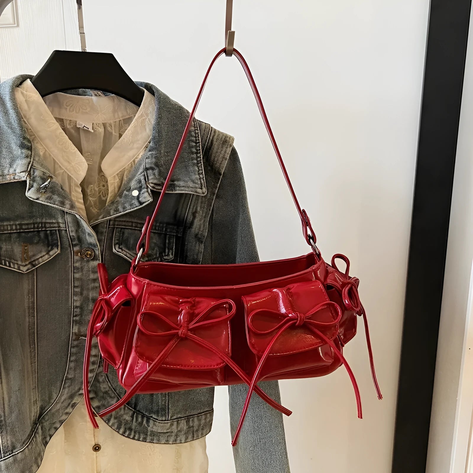 Women's large shoulder bag with bow and tassel decoration, showing multi-pocket sandwich pocket design.