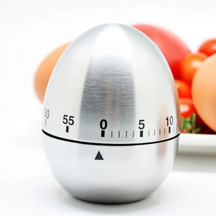 Stainless steel egg-shaped mechanical kitchen timer on countertop