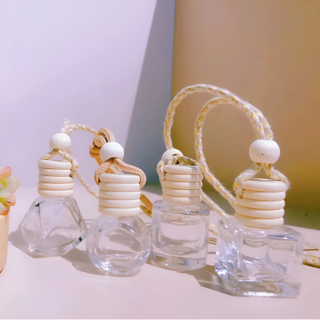 Glass car perfume pendant fragrance diffuser in cylinder, diamond, flat drum, and square styles.