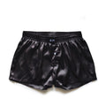 Men's low-waist silky boxer polyester pajama shorts in black brown, front view on white background