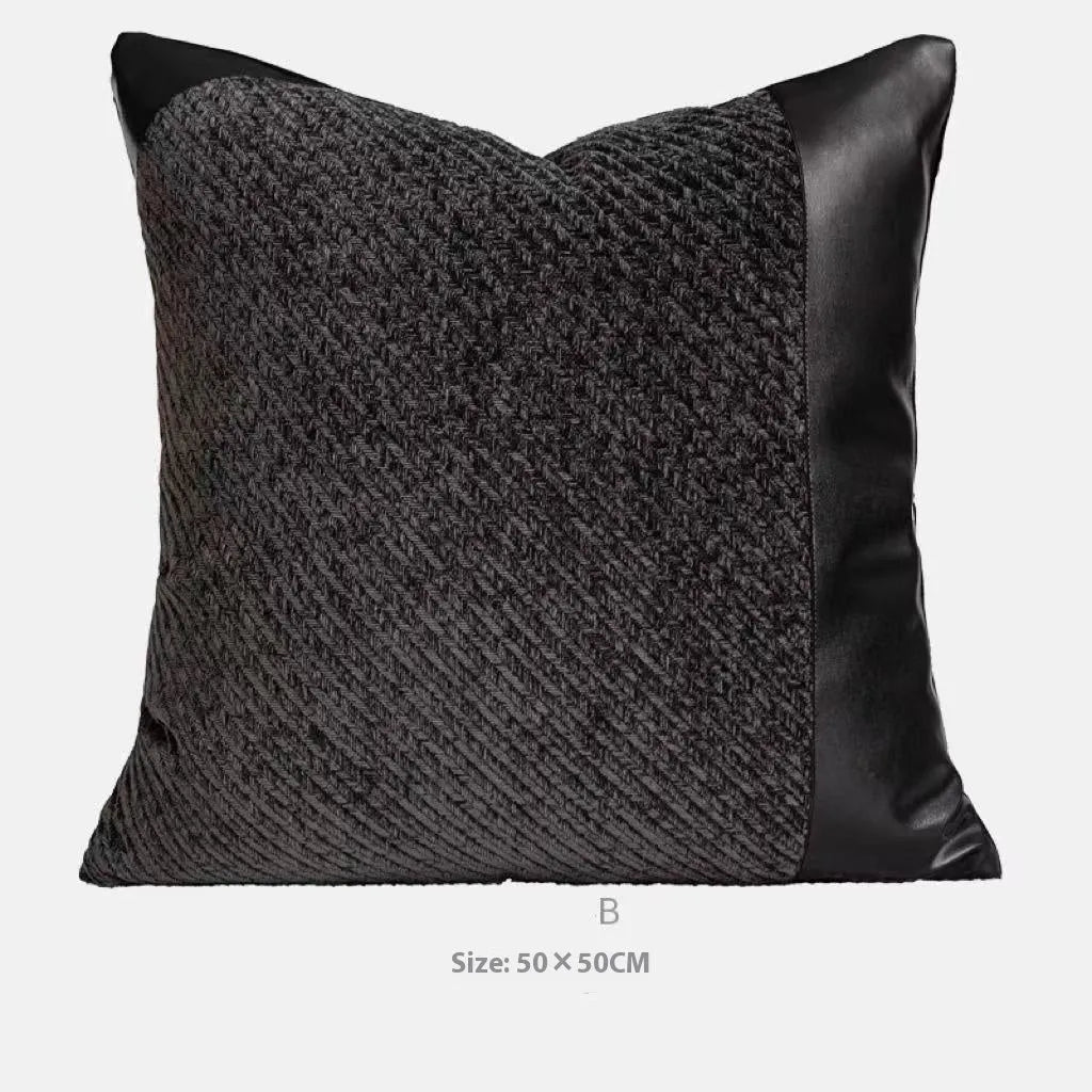 Modern grey and white plaid bed runner blanket set with round leather pillow on a bed.