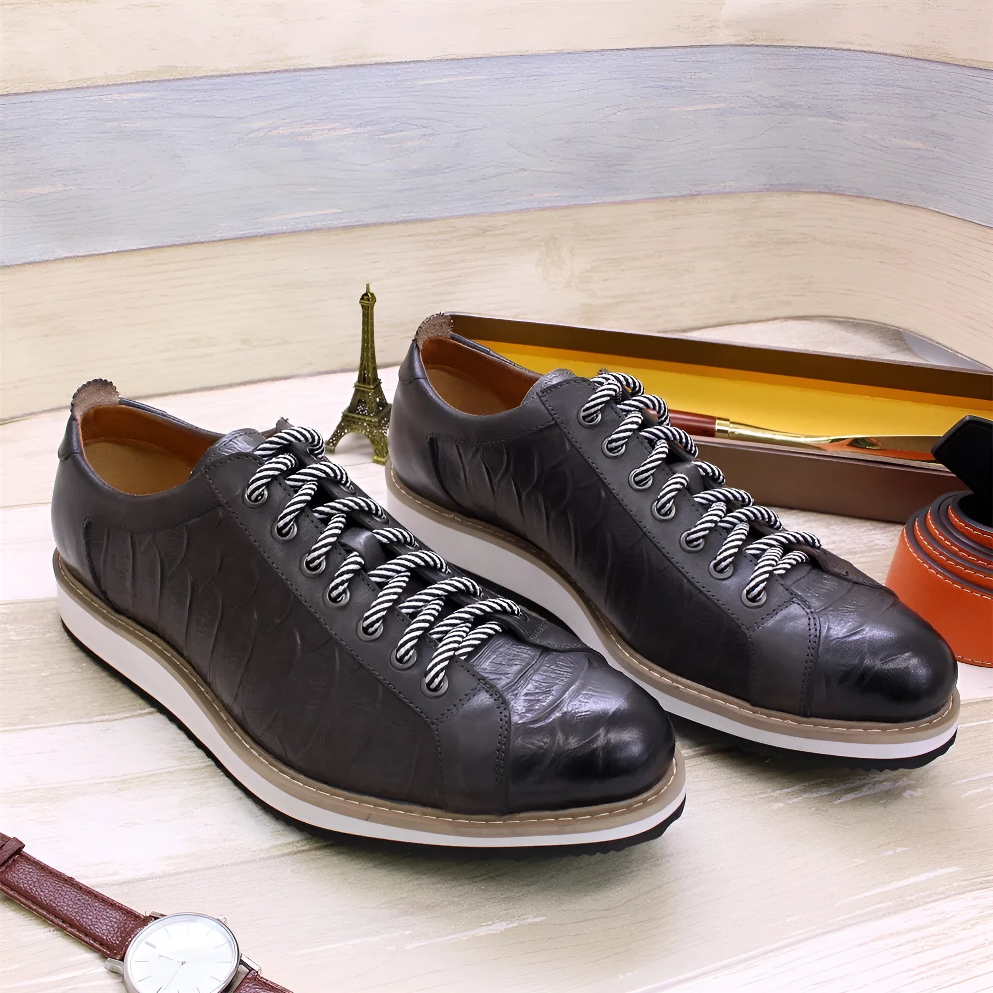 Men's low-top handmade shoes with embossed pattern detail on the upper and front lace closure.