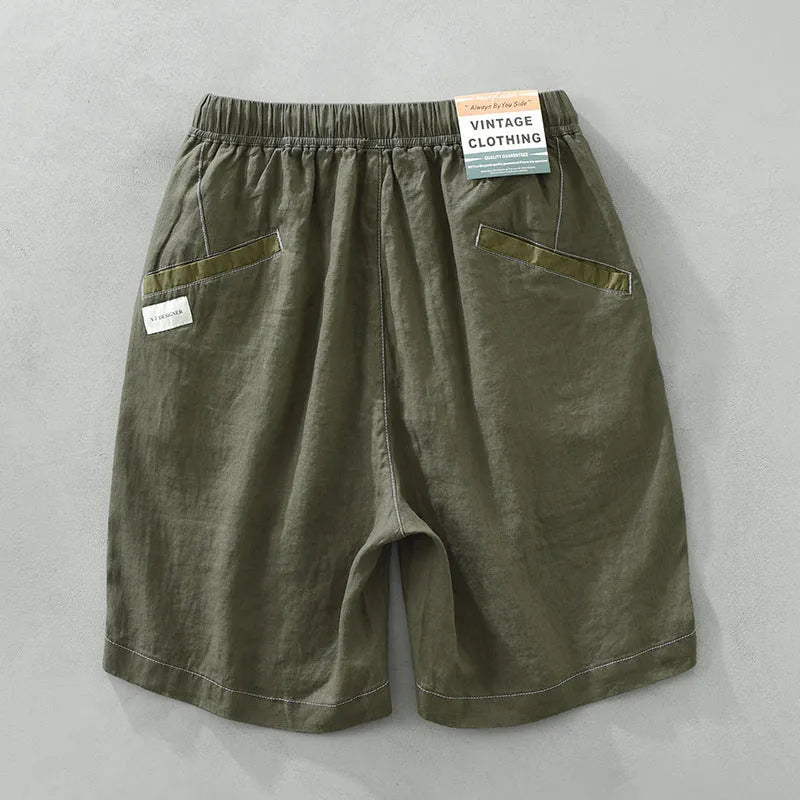 Men's loose straight leg linen shorts in green with drawstring waist and mid thigh length