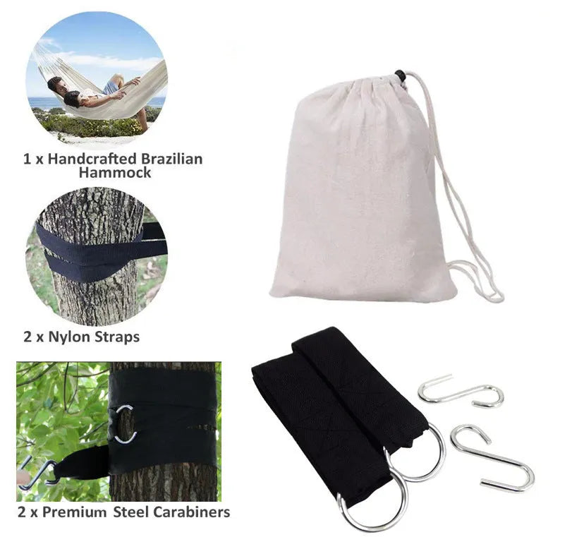 Cotton camping hammock with strap and bandage set up between trees for outdoor use