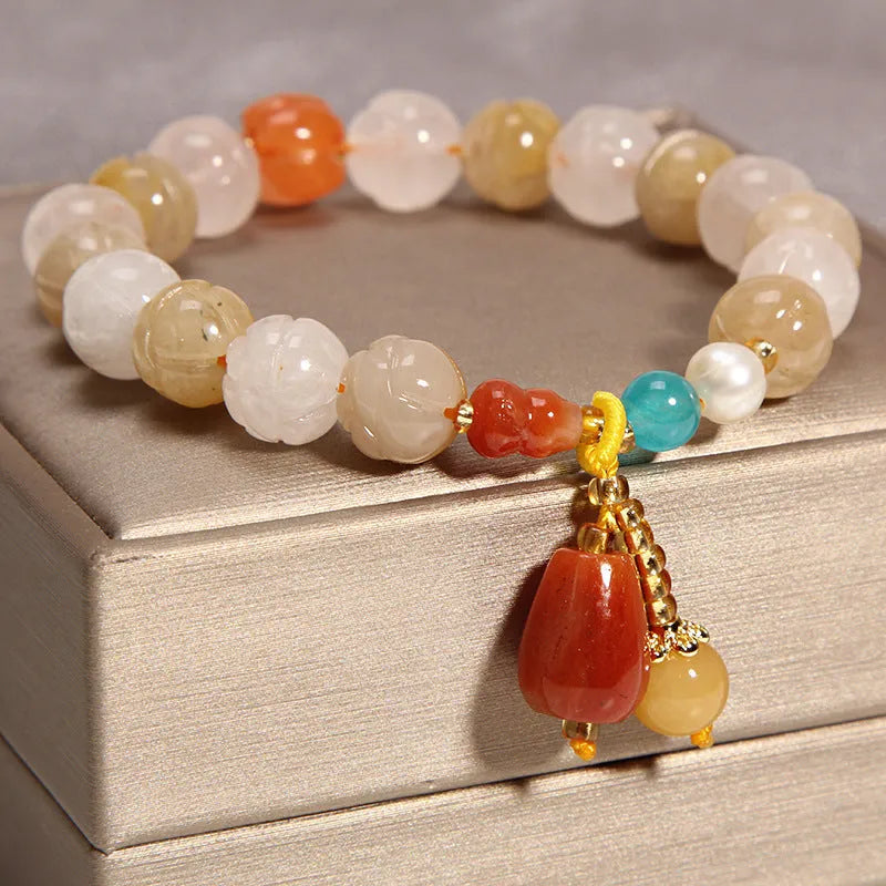 Khaki coloured crystal bracelet for women with an adjustable gold silk cord fastening.