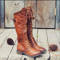 Women's black fashion boots with a cross strap design and side zip closure.
