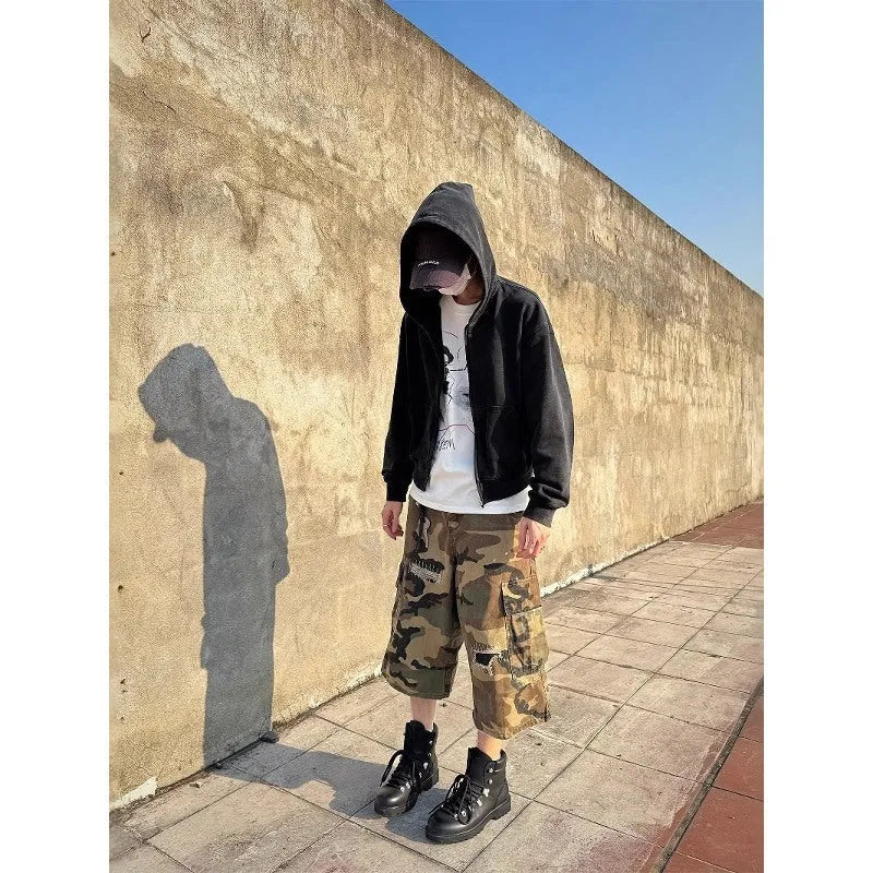 Men's camouflage cropped jeans with ripped detailing and retro patches in loose straight cut