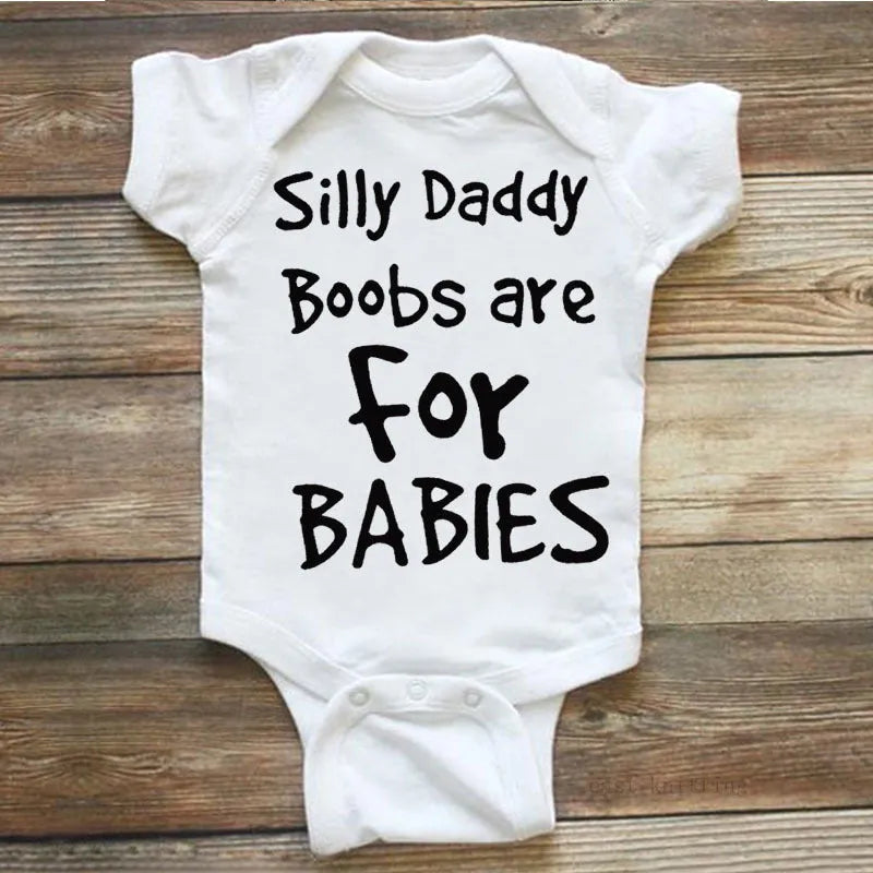 White triangle climbing vest top with printed text 'Silly Daddy Boobs Are For Babies' on the front