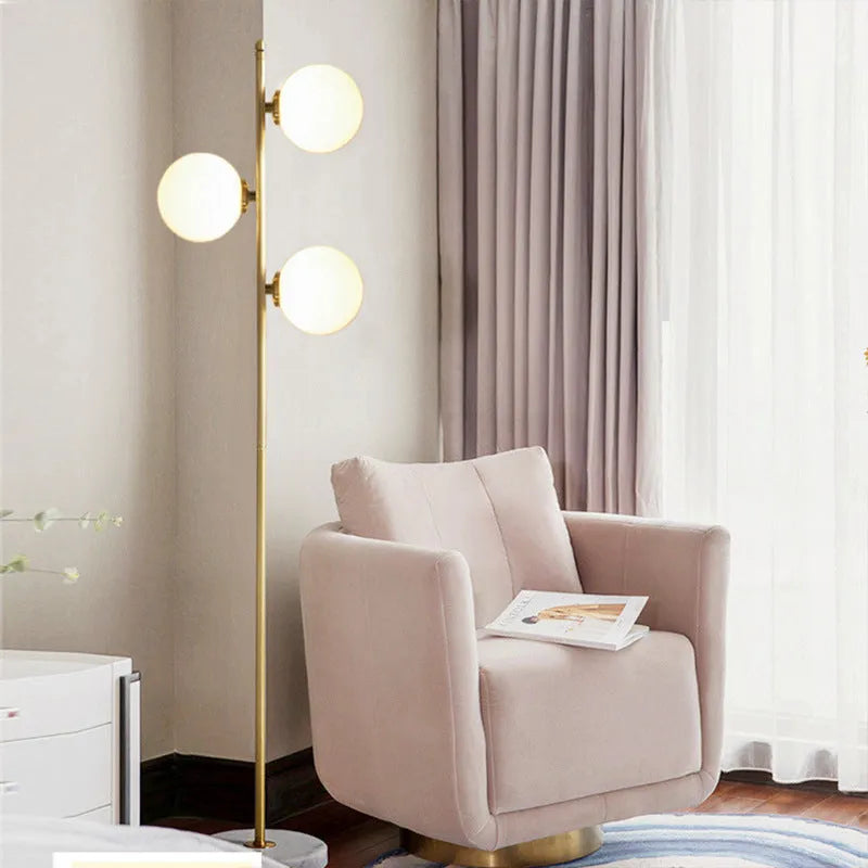 Creative minimalist floor lamp with warm LED light, gold aluminium alloy frame and glass shade