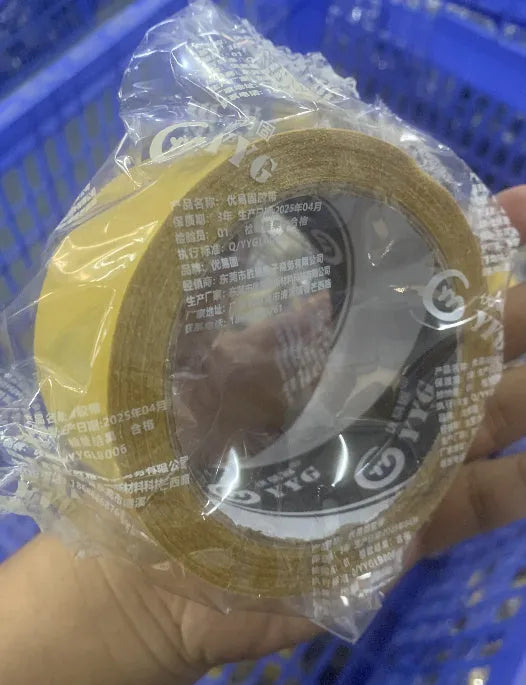 Roll of yellow grid double-sided cloth tape 5cm wide 20m long on white background