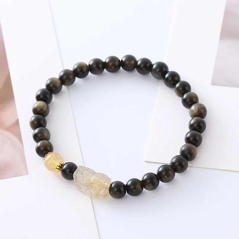 Natural obsidian Pi Xiu bracelet with gold obsidian stone and red flower design