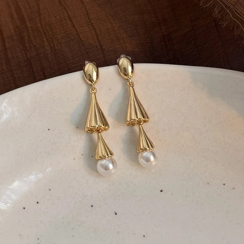 Gold geometric fringe ear clip earrings with long wind chime mosquito coil plate design on copper base