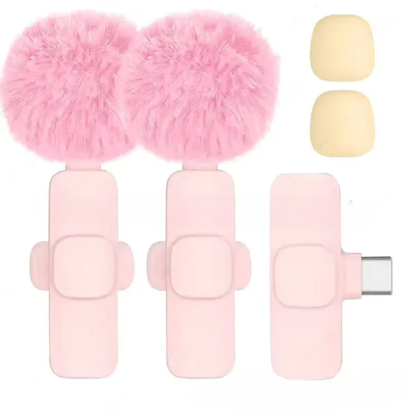 Pink K1K9 one-drag wireless microphone with receiver, charging cable, and hairball windshield on a table
