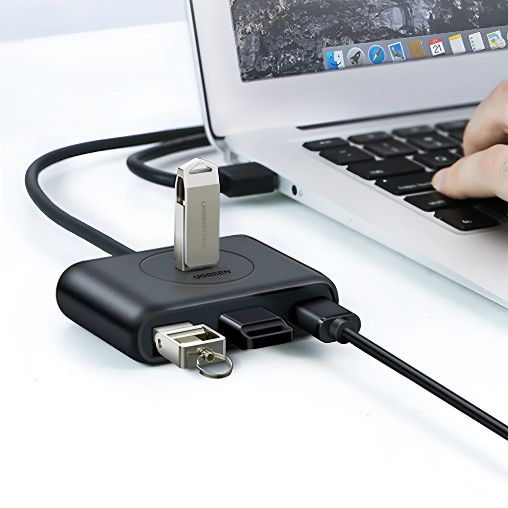 Deep black USB splitter with four ports, Micro USB power port, and indicator light on a desk