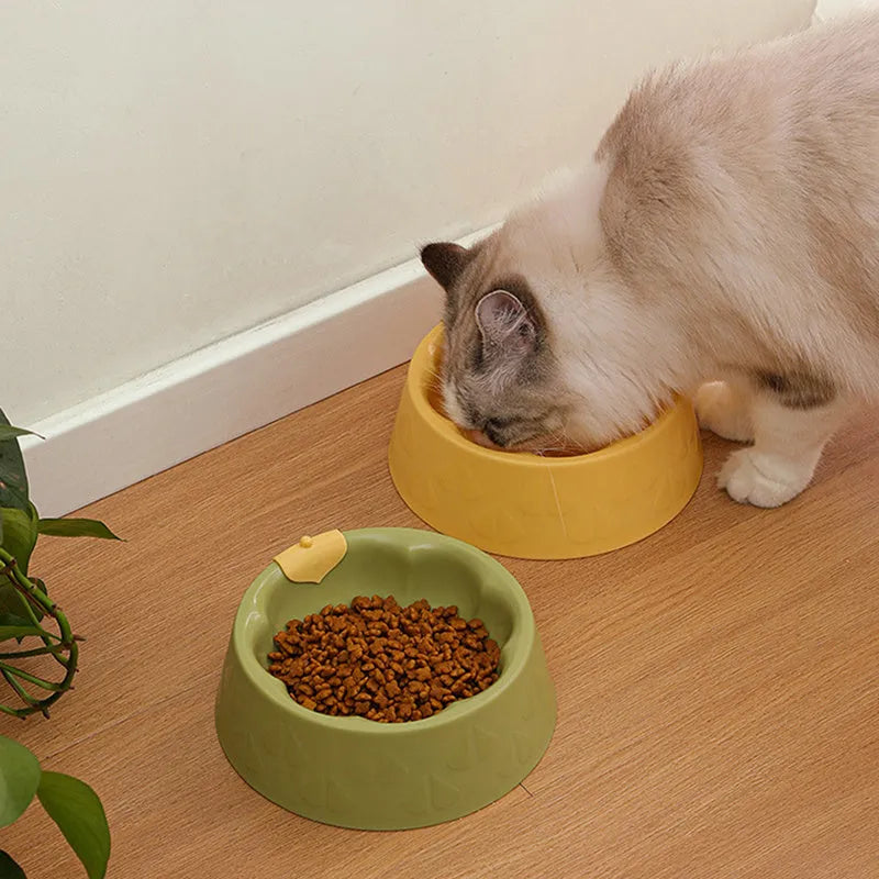 Green plastic double pet bowl with flower-shaped design and anti-tip base for cats and small dogs.