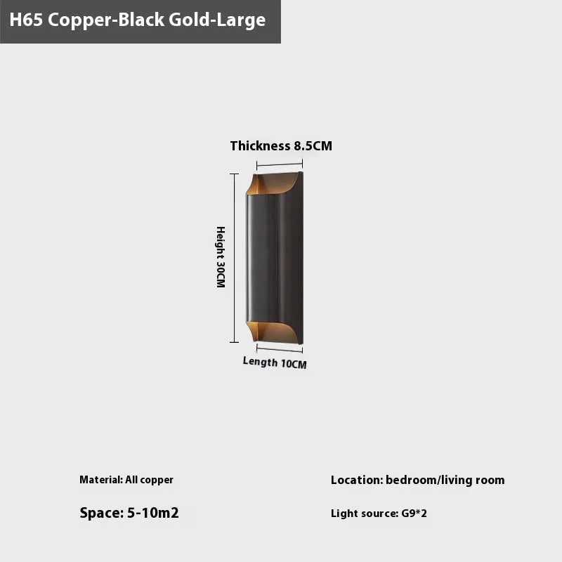 Minimalist copper wall lamp in black gold finish mounted beside a bed.
