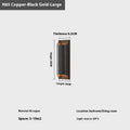 Minimalist copper wall lamp in black gold finish mounted beside a bed.