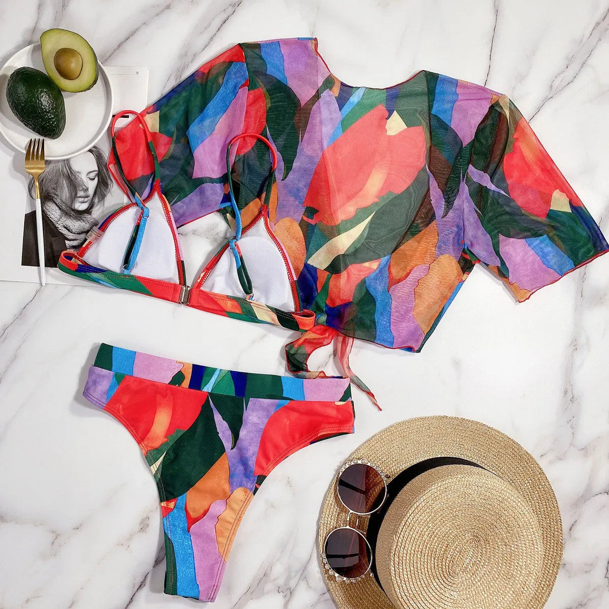 Red women's split-leg bikini swimsuit with triangle top on a mannequin.
