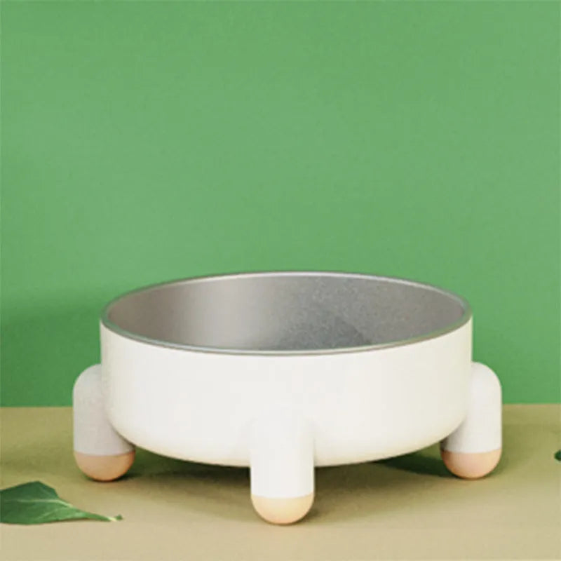 Green ceramic-coated stainless steel pet bowl with non-slip base and raised high-foot design.