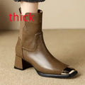 Brown women's knee-high cowhide leather Martin boots with a heel and side zipper detail.