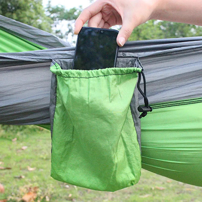 Sapphire blue parachute nylon camping hammock hung between two trees, showing its full 270cm length.