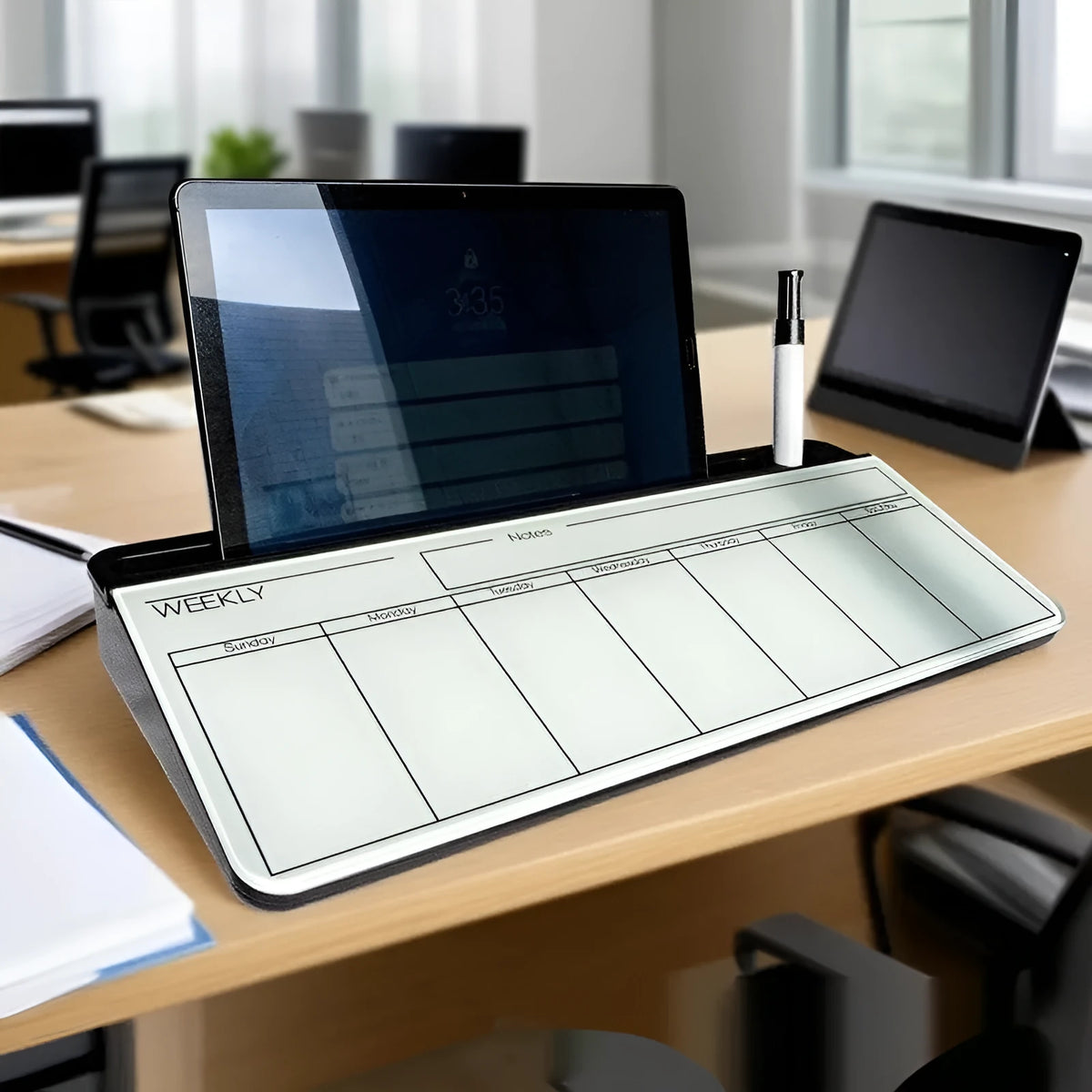 Table top glass whiteboard 18x40cm in black frame on a desk with markers