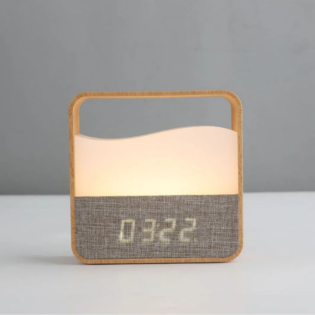 Wood grain geometric stereo alarm clock night lamp with remote control on a bedside table