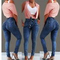 Pair of light blue fringed jeans with distressed hem detailing on a denim background.