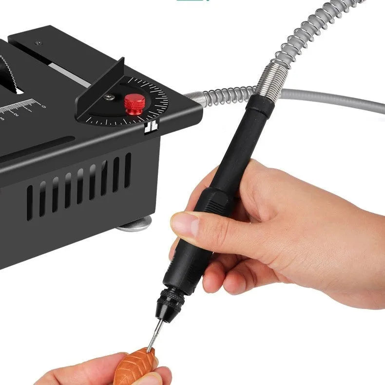 Lithium-ion battery-powered micro desktop saw with metal body on a workbench.