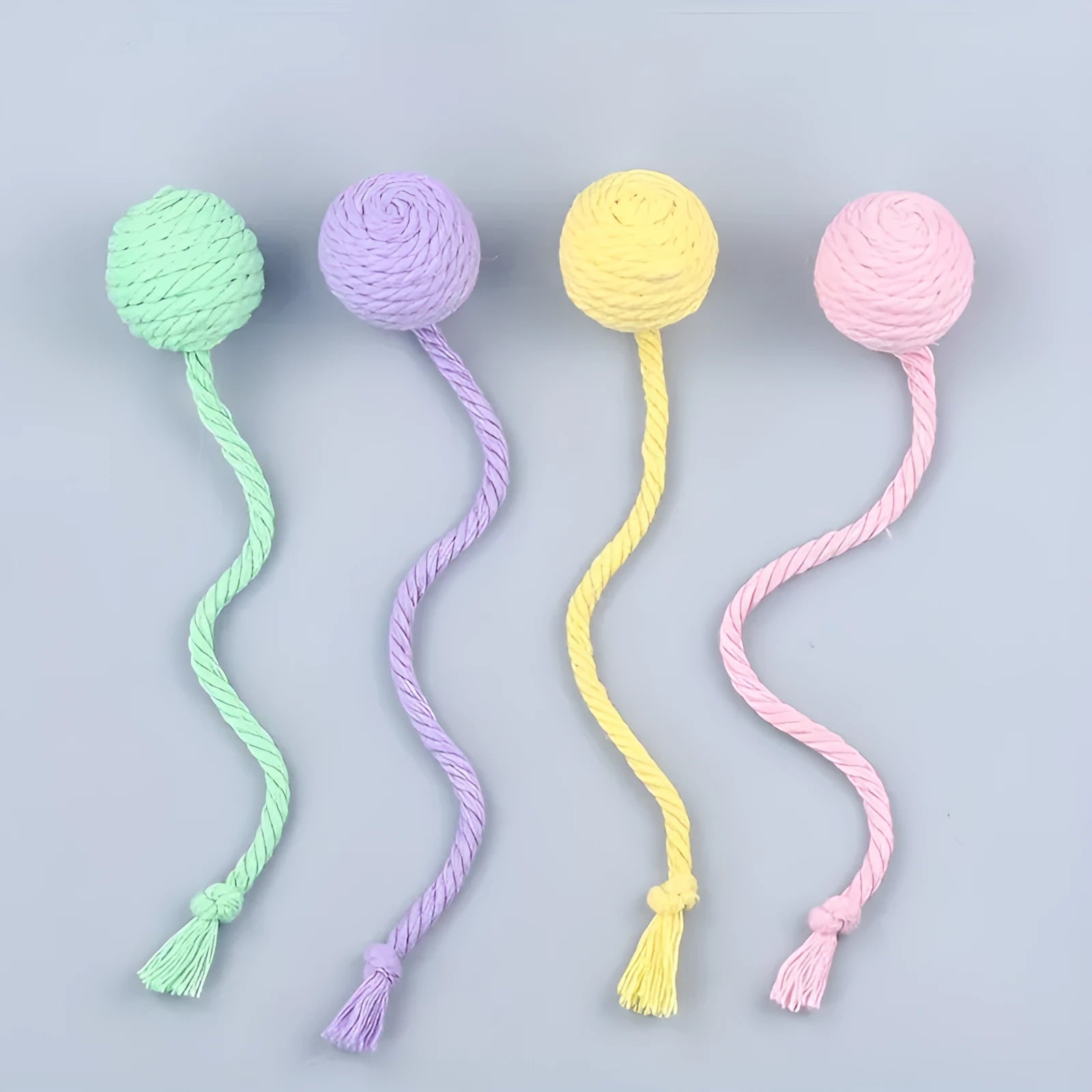 Cat toy ball with rope attached in green, pink, purple or yellow colour with internal bell