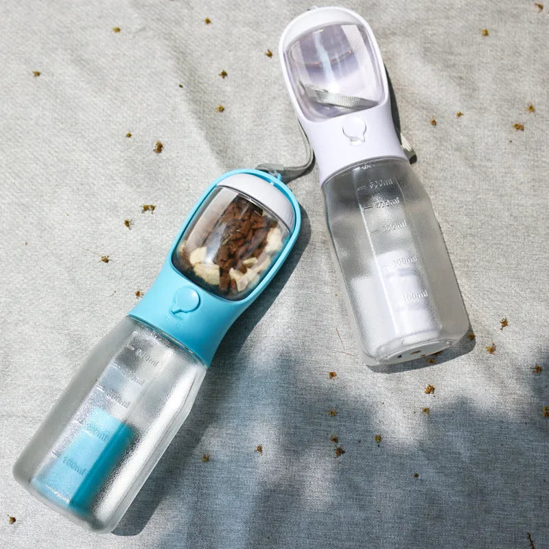 Turquoise portable 3-in-1 dog water bottle with food feeder and built-in poop bag dispenser on a walk
