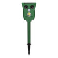 Dark green solar-powered animal repeller with infrared sensor on a garden lawn